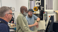 As part of the partnership, Southern Regional Technical College Instructor Marvin Bannister (center) received hands-on training on advanced machining equipment to prepare for teaching Georgia’s next generation of manufacturers.